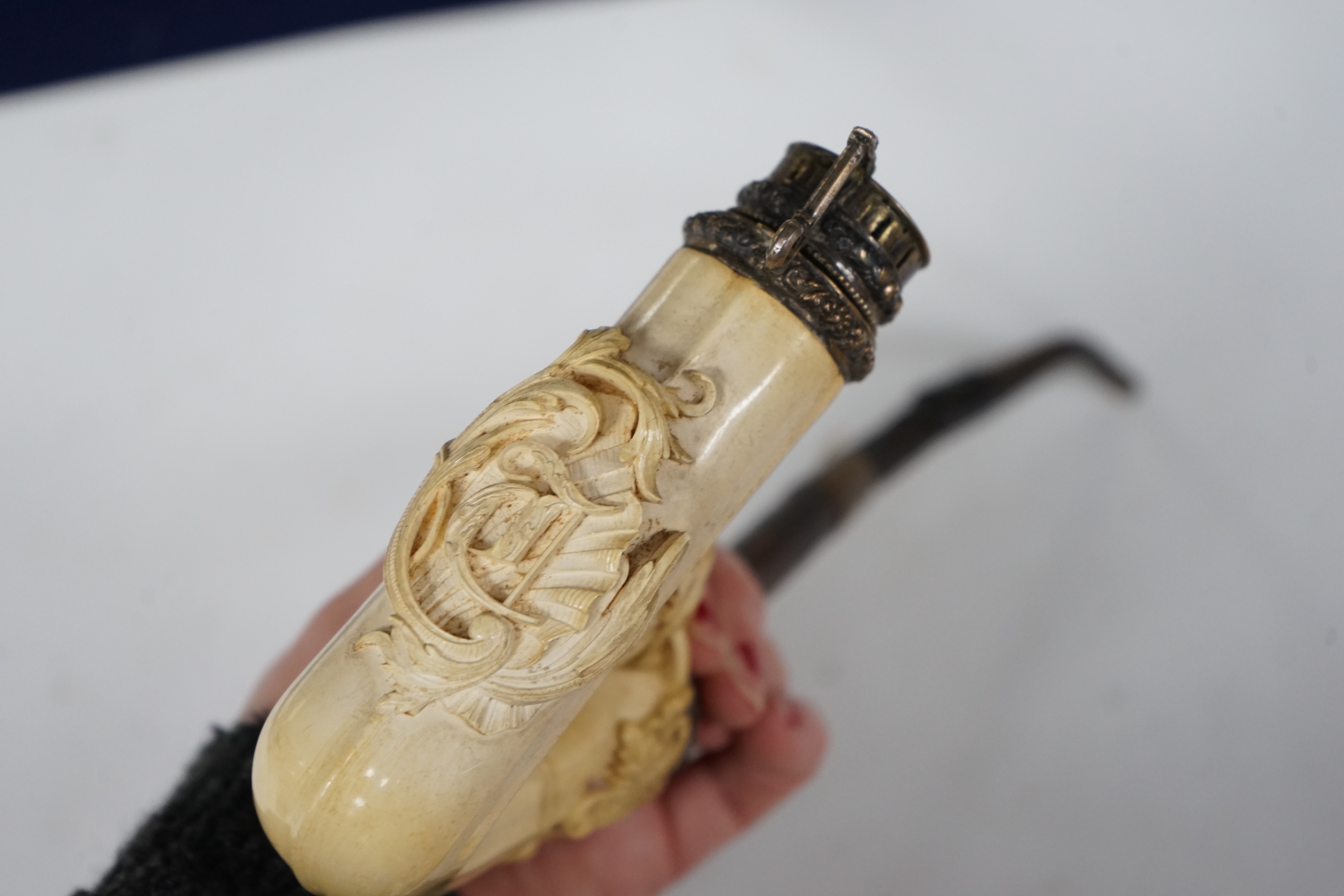An ornate Meerschaum pipe, with carved monogram on the bowl and metal cover, 30cm long
